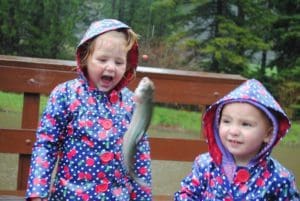 Young girls looking at caught trout